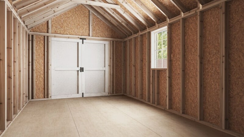 The interior of a 12x16 shed from Ulrich, featuring unfinished walls and high-quality framing.